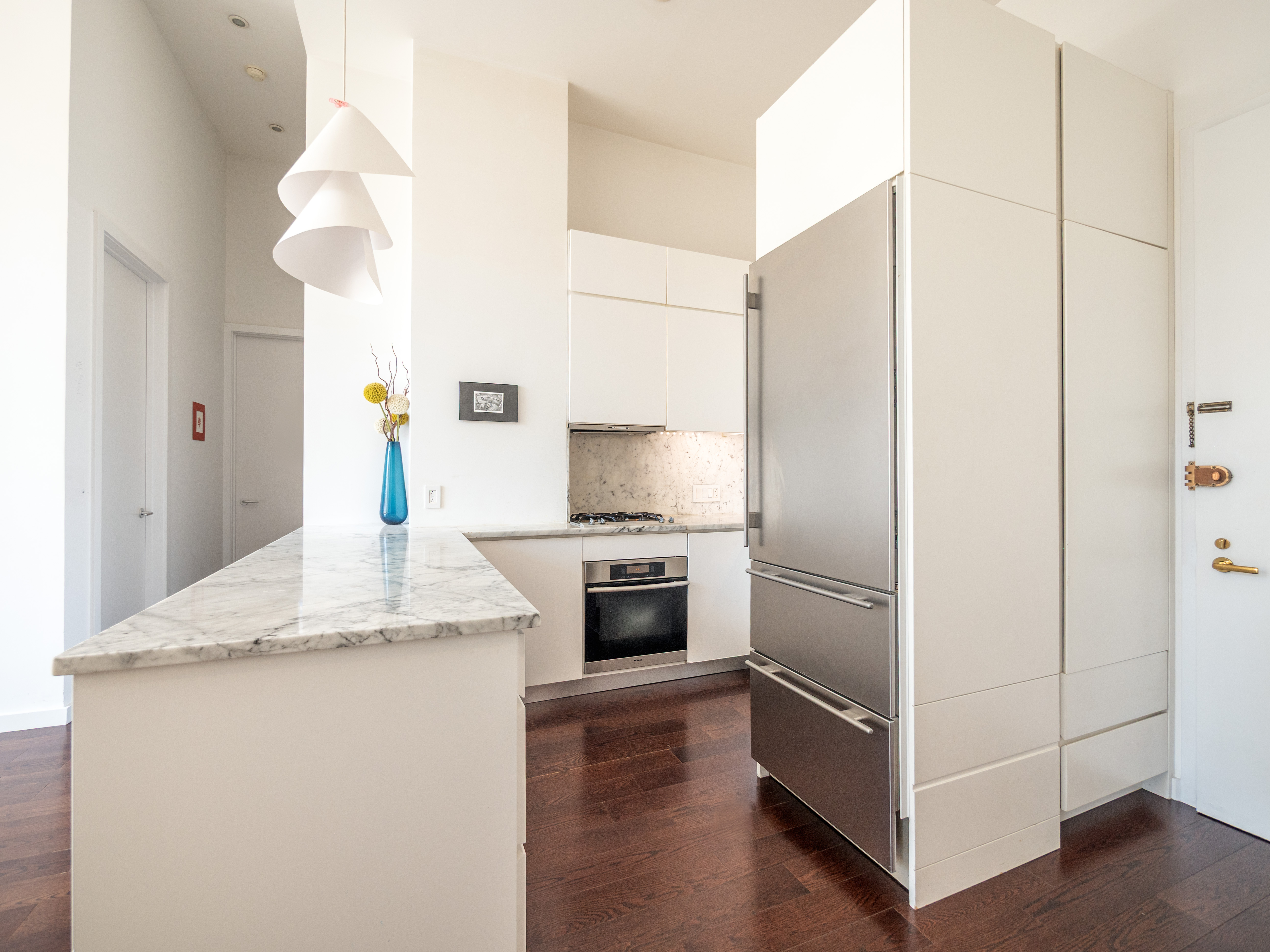 120 East 87th Street, Unit R6IJ Manhattan, NY 10128 - Photo 8 of 27 a kitchen with a refrigerator and a sink