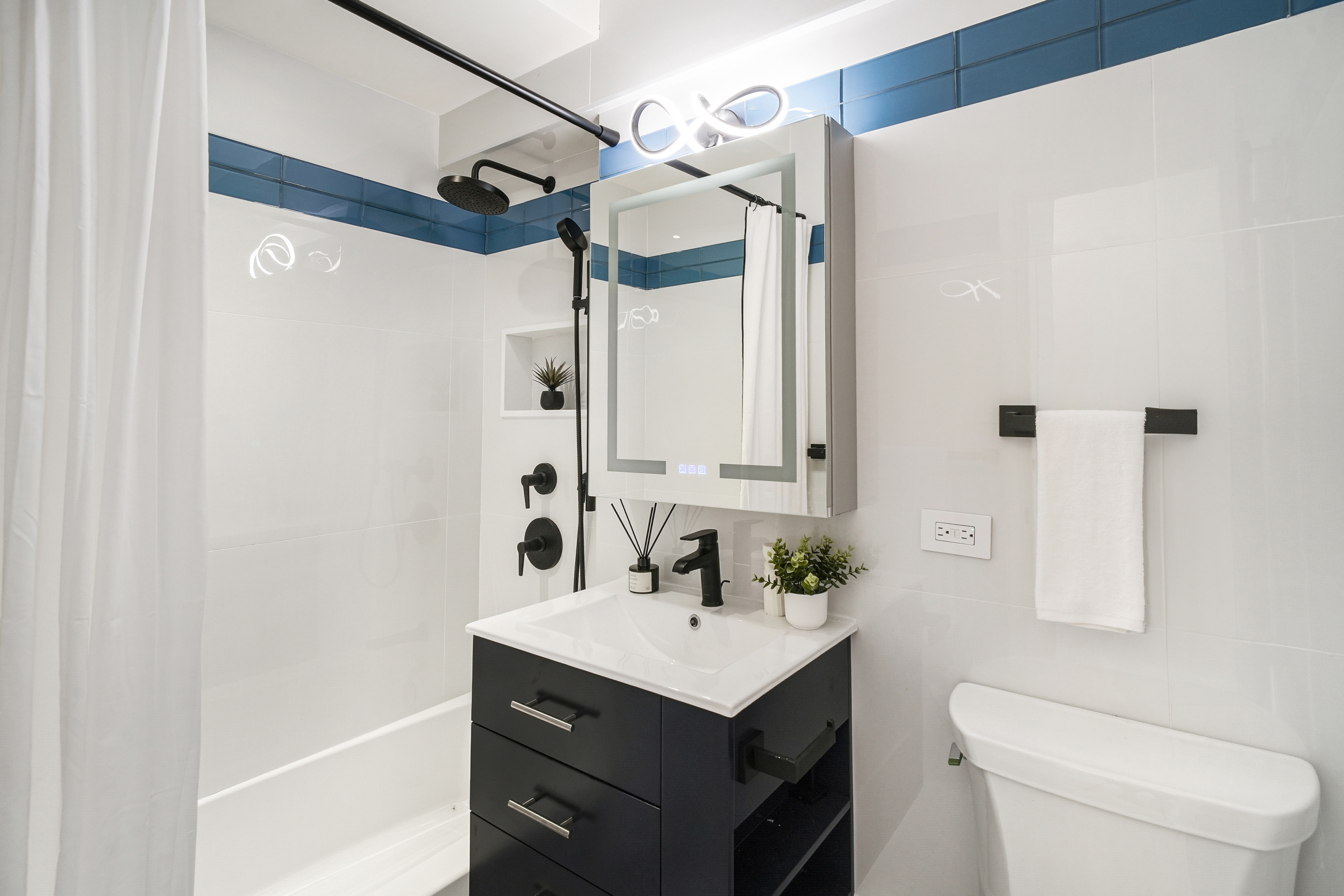 31 Jane Street, Unit 10FG Manhattan, NY 10014 - Photo 18 of 27 a bathroom with a sink vanity mirror and toilet