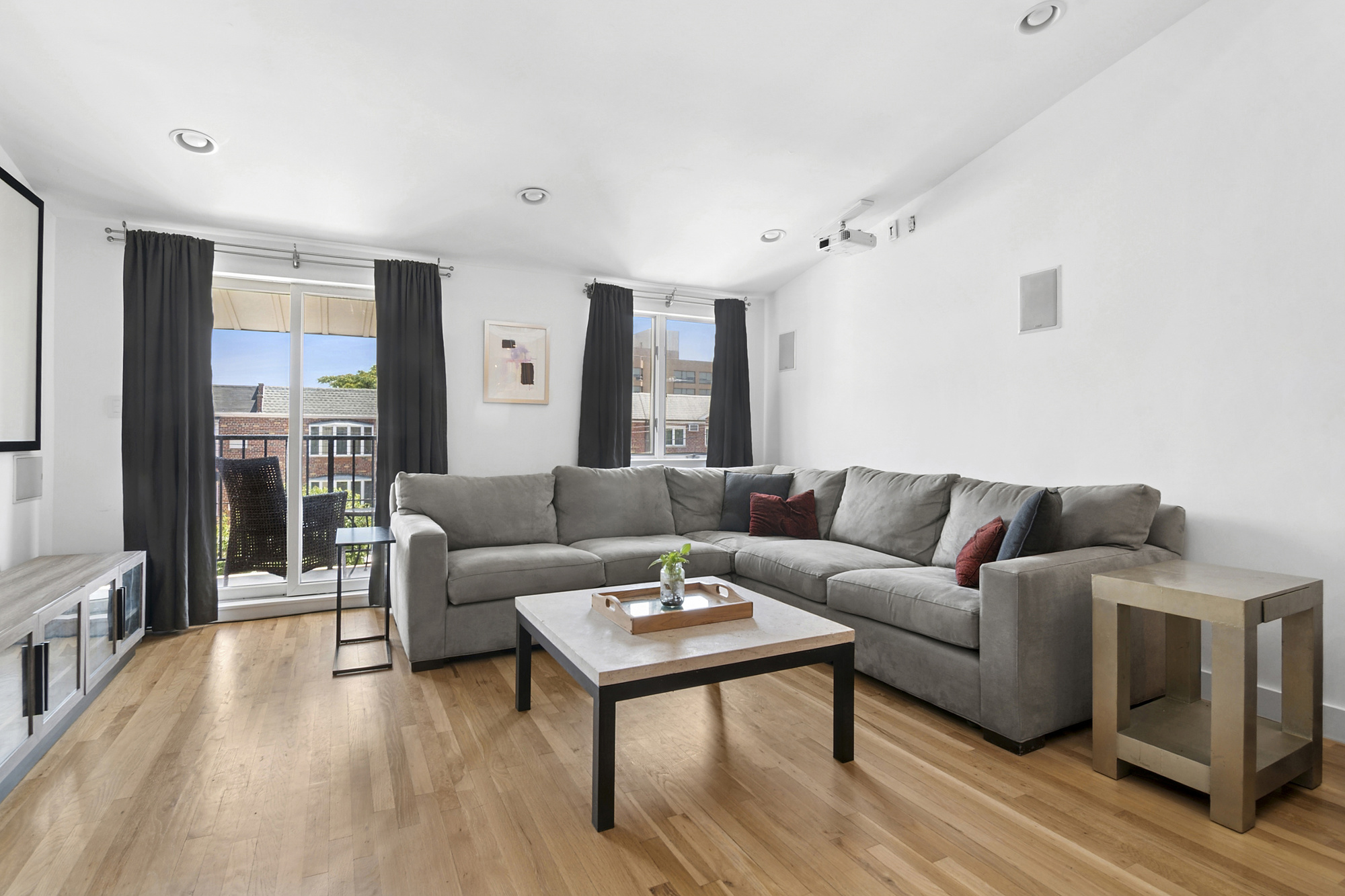 106 Battery Avenue, Unit 301 Brooklyn, NY 11209 - Photo 4 of 8 a living room with furniture and a wooden floor