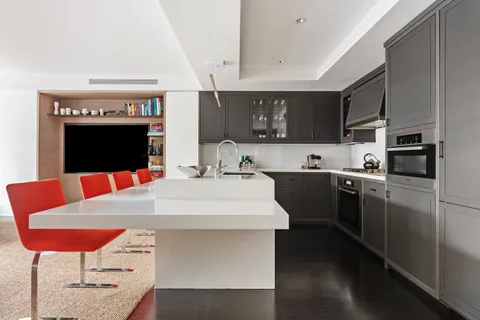 a kitchen with stainless steel appliances kitchen island granite countertop a refrigerator a stove a sink dishwasher with a dining table and chairs