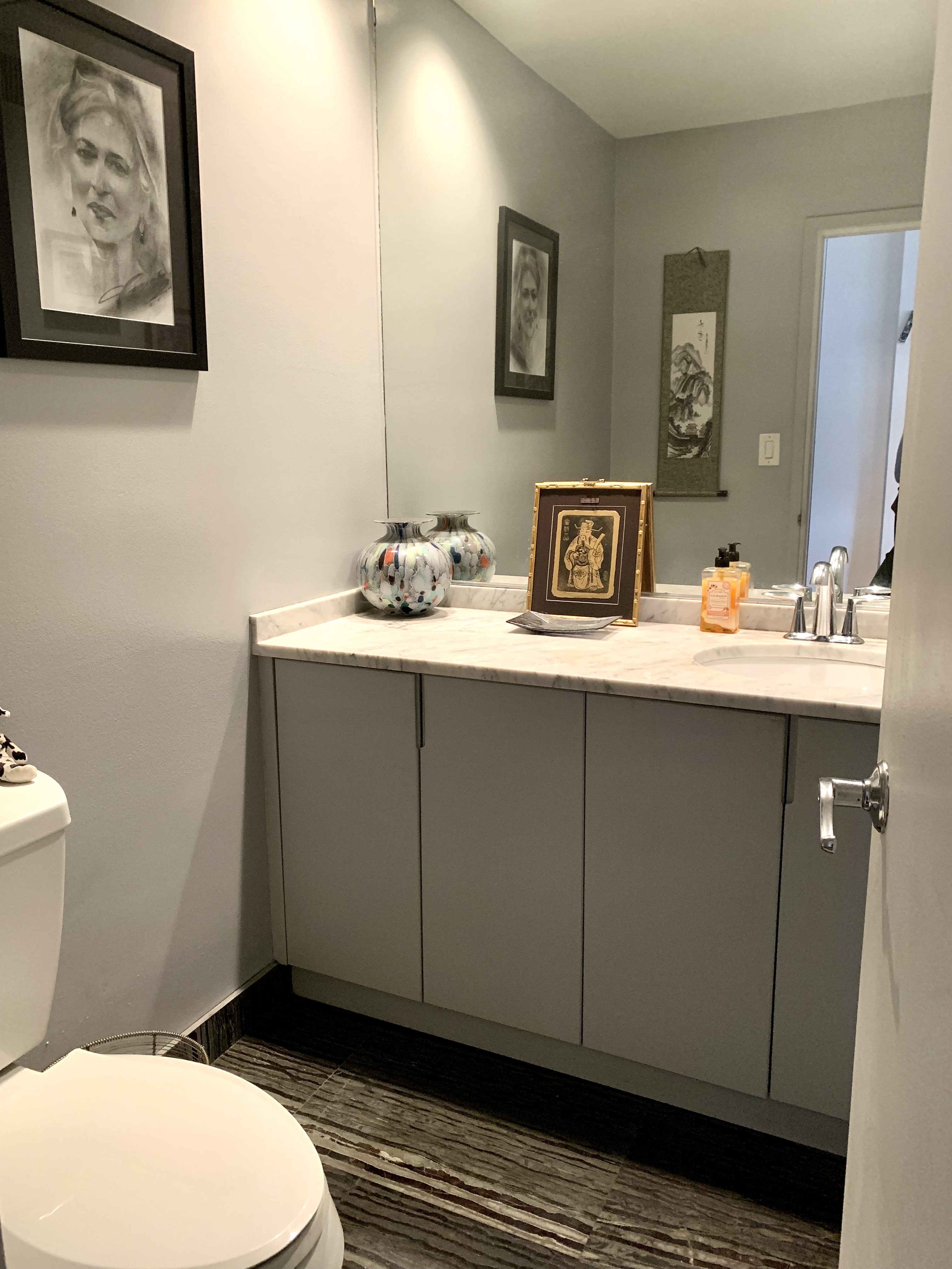 130 Barrow Street, Unit PH508 Manhattan, NY 10014 - Photo 10 of 14 a bathroom with a toilet sink and mirror