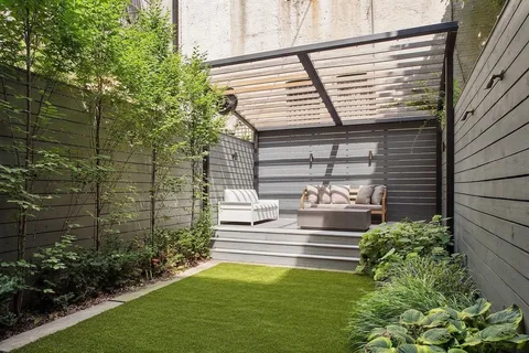 a front view of a house with a garden