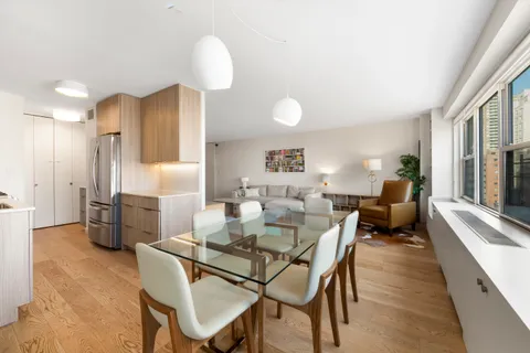 a view of a dining room with furniture and a chandelier