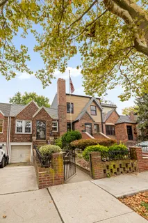 a view of a patio with couches and table and chairs under an umbrella