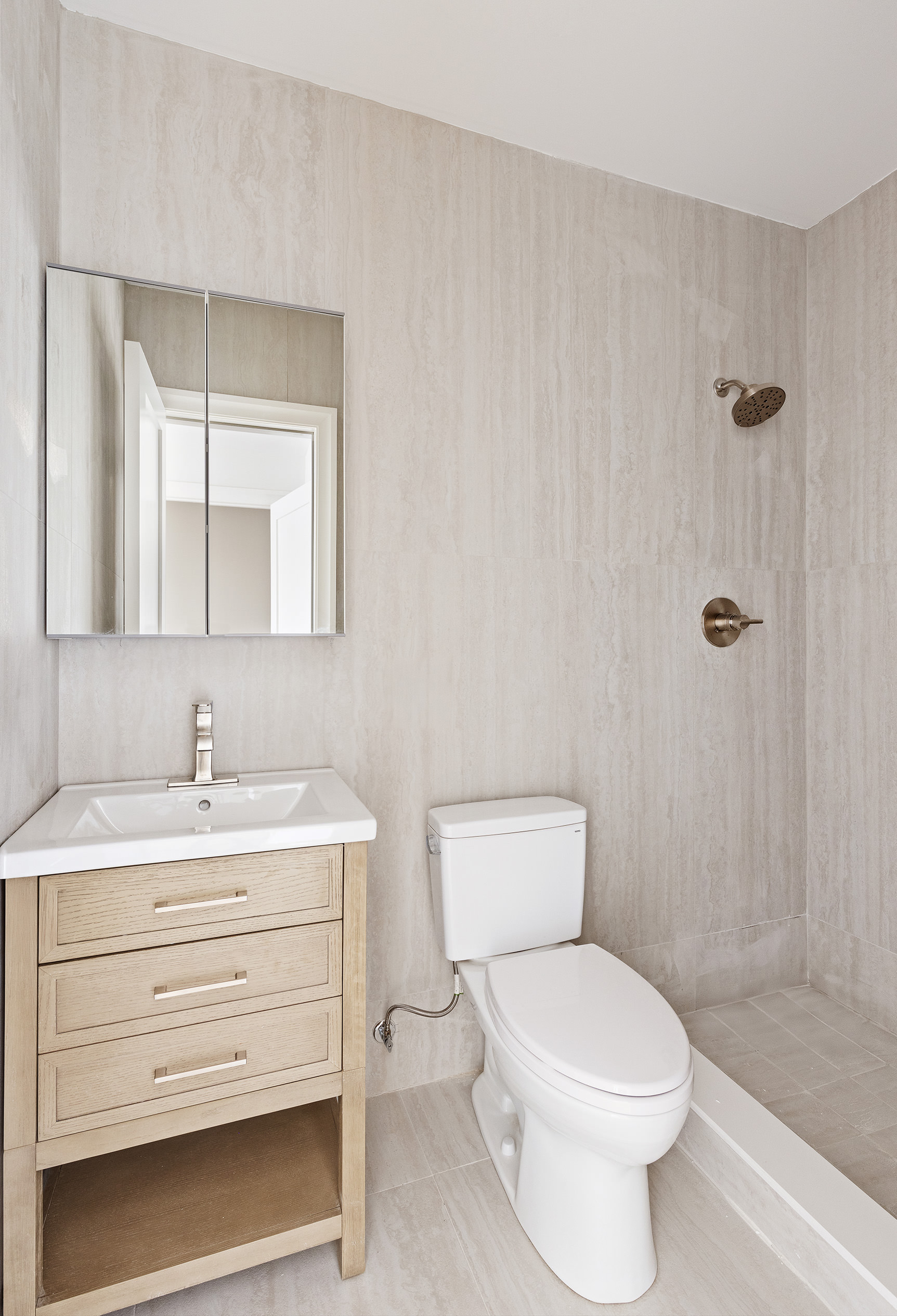 80 7th Avenue, Unit 4 Brooklyn, NY 11217 - Photo 7 of 9 a bathroom with a toilet a sink a mirror and vanity