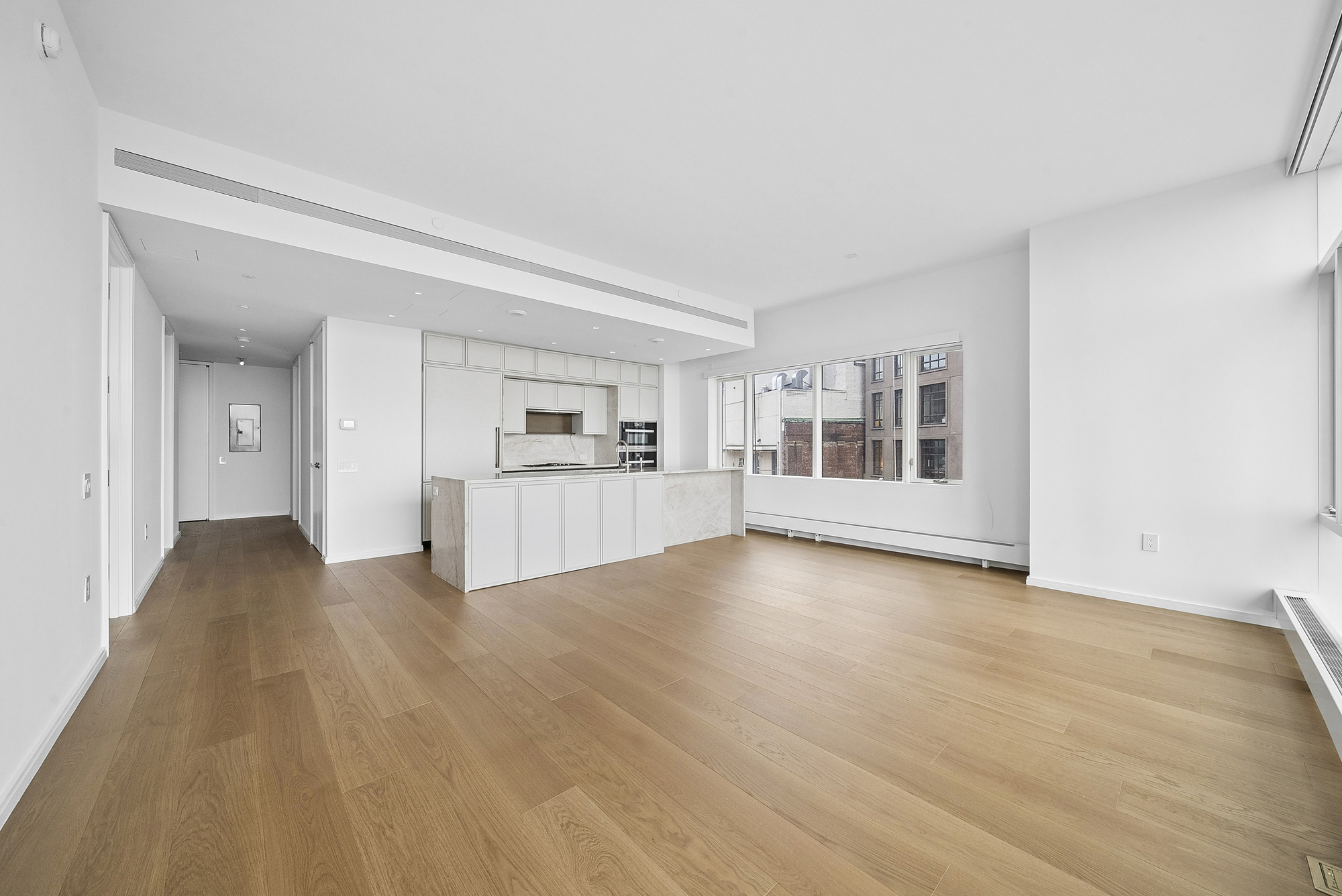 5 Beekman Street, Unit 30A Manhattan, NY 10038 - Photo 5 of 15 a view of empty room with wooden floor and kitchen view