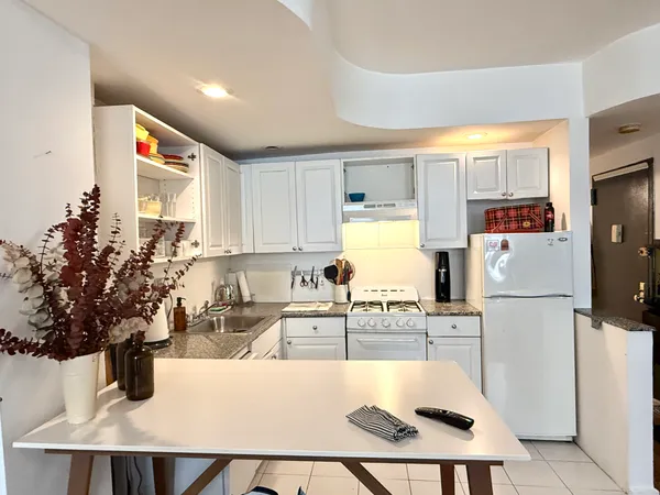 a kitchen with a sink a counter top space and cabinets