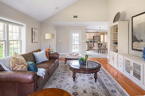 a living room with furniture and a dining table