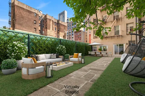 a view of a patio with couches and a fire pit