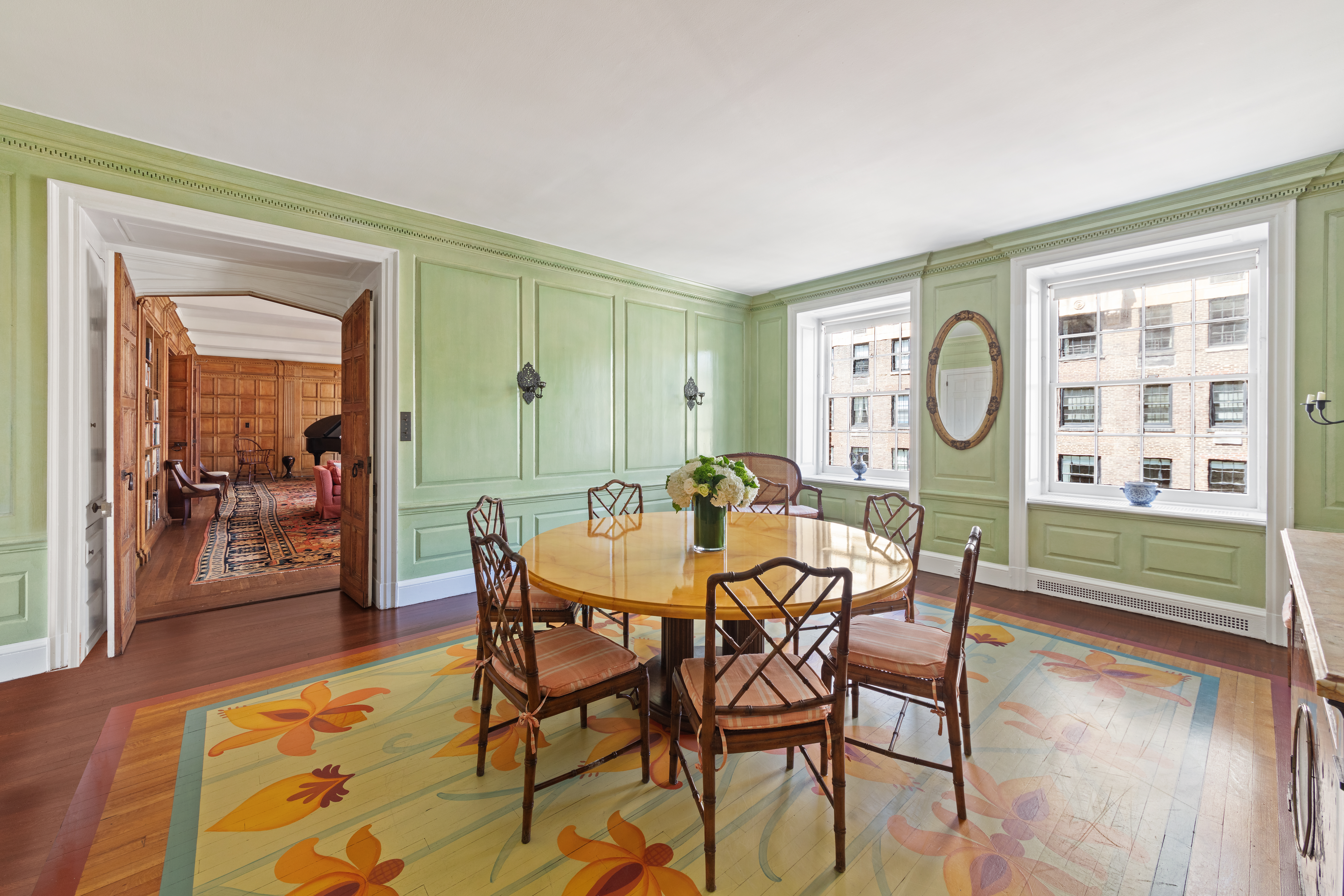 151 East 79th Street Manhattan, NY 10075 - Photo 5 of 15 a view of a dining room and livingroom with furniture wooden floor a chandelier