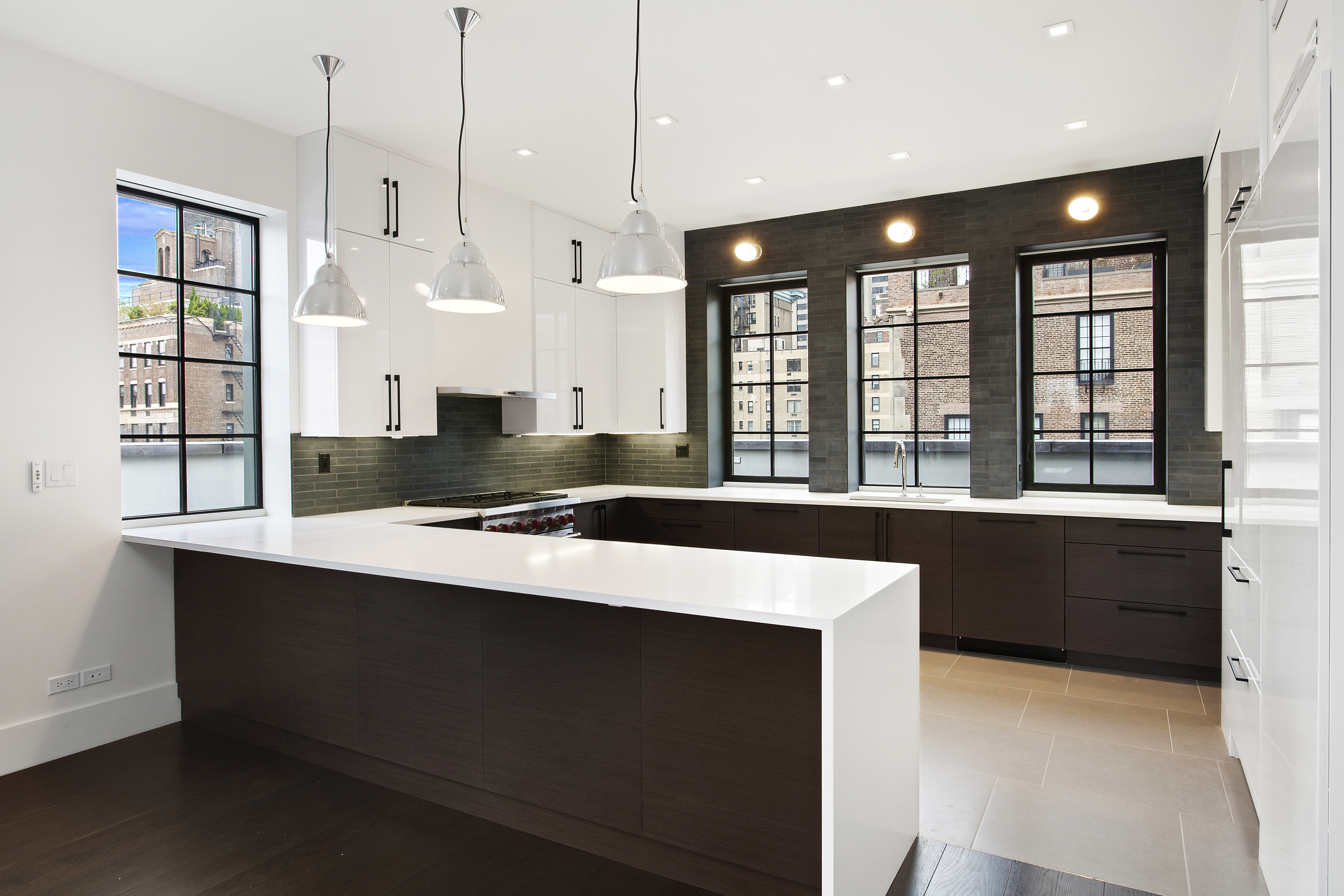 East 80th Street Manhattan, NY 10075 - Photo 4 of 13 a large kitchen with kitchen island a sink appliances and a large window