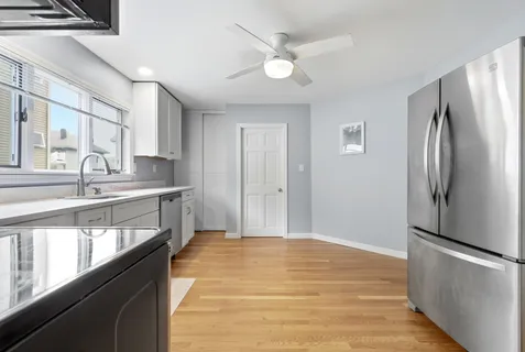 a kitchen with stainless steel appliances granite countertop a refrigerator and a sink