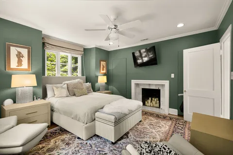 a bedroom with a large bed and a fireplace