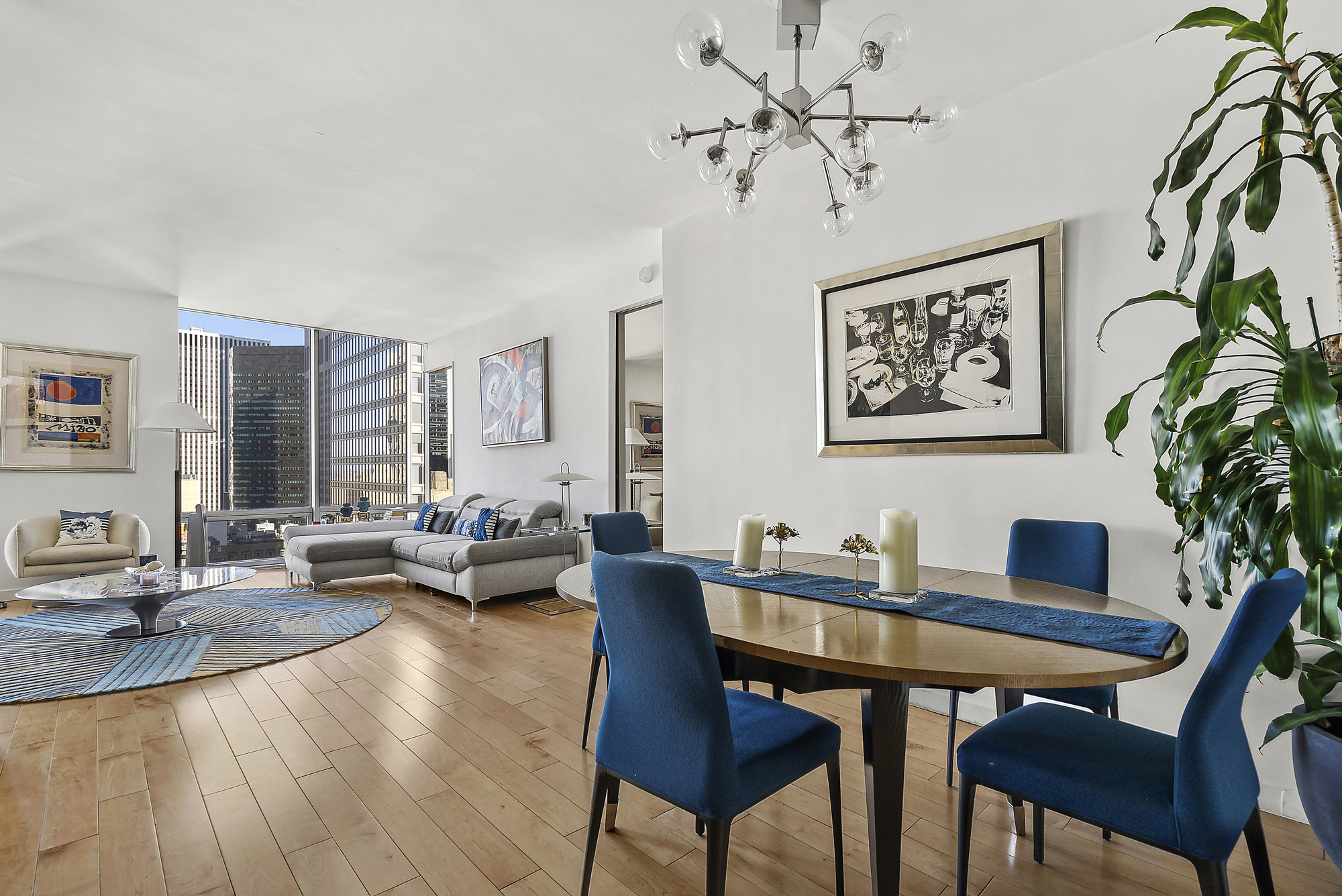 641 5th Avenue, Unit 28B Manhattan, NY 10022 - Photo 4 of 12 a living room with furniture and wooden floor