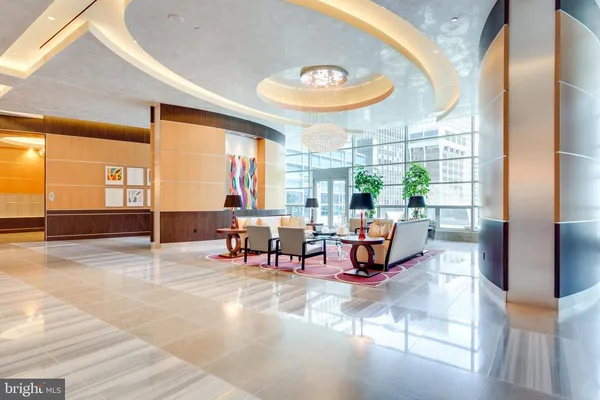 a lobby with furniture and wall paintings