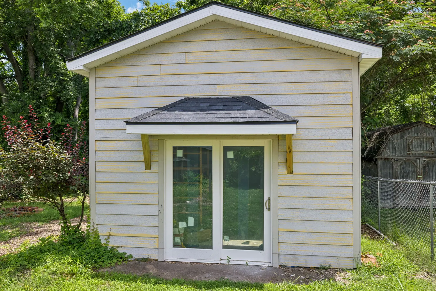 a front view of a house with a garden