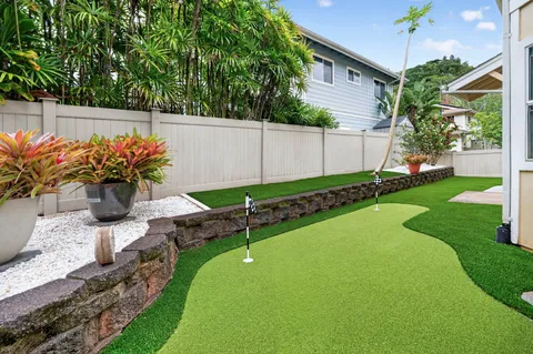 a view of a house with backyard and sitting area