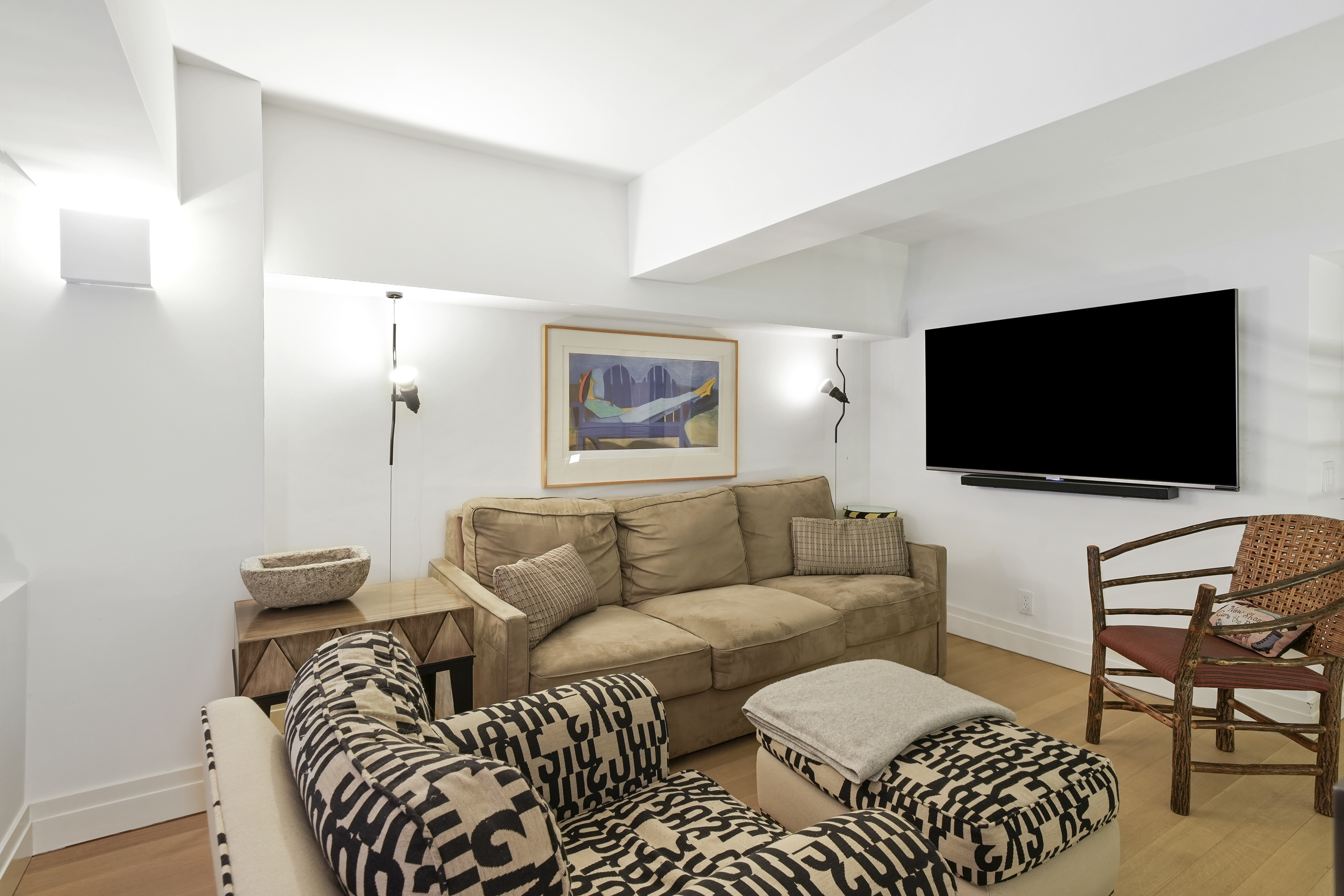 421 Hudson Street, Unit 221 Manhattan, NY 10014 - Photo 8 of 12 a living room with furniture and a flat screen tv