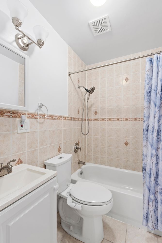 756 Barbey Street, Unit 1A Brooklyn, NY 11207 - Photo 7 of 9 a bathroom with a sink a toilet and shower