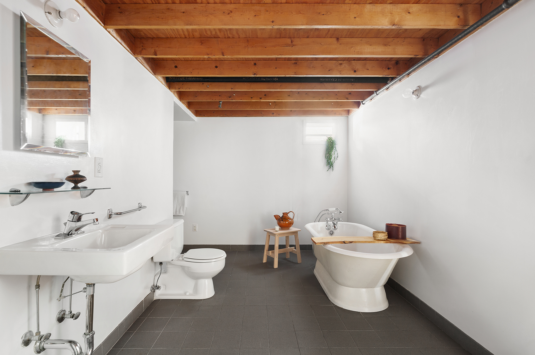 135 Greene Street, Unit 2N Manhattan, NY 10012 - Photo 12 of 13 a white toilet sitting next to a bathroom sink
