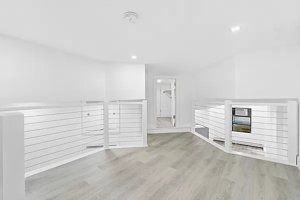 74 Leonard Street, Unit 5B Manhattan, NY 10013 - Photo 2 of 6 a view of a livingroom with white walls