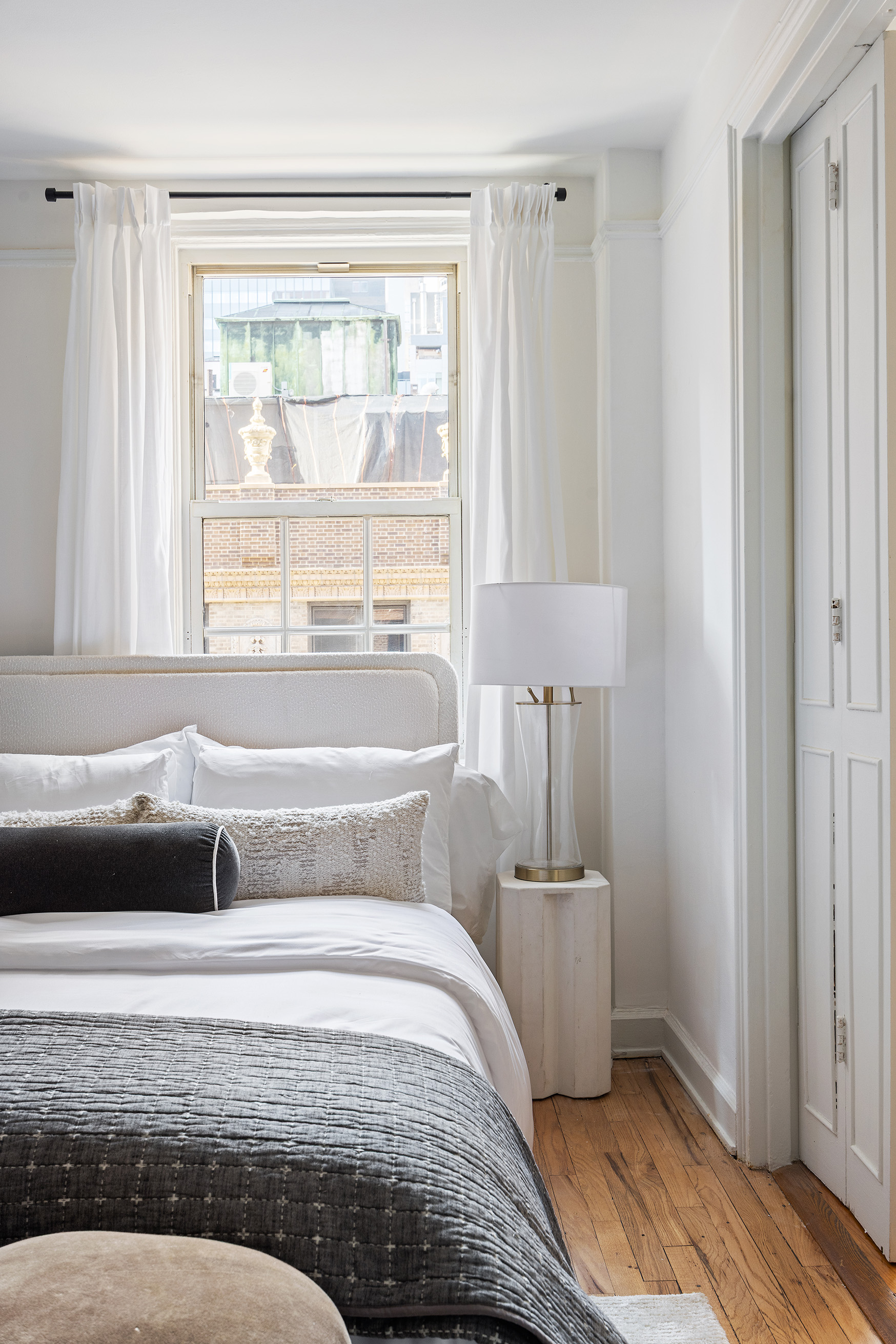155 East 49th Street, Unit 10A Manhattan, NY 10017 - Photo 9 of 16 a bedroom with a bed and wooden floor