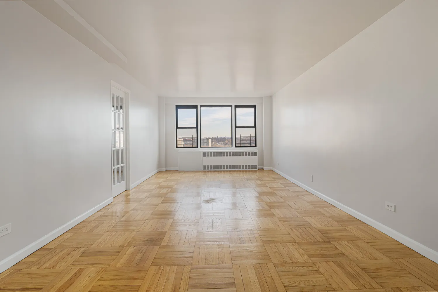 an empty room with large windows