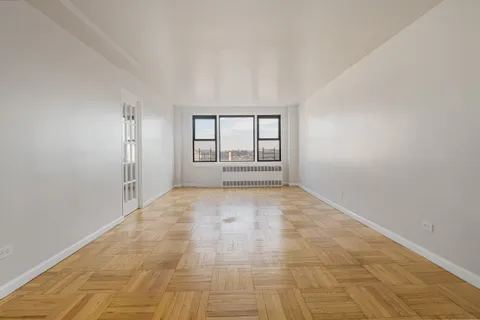 an empty room with large windows