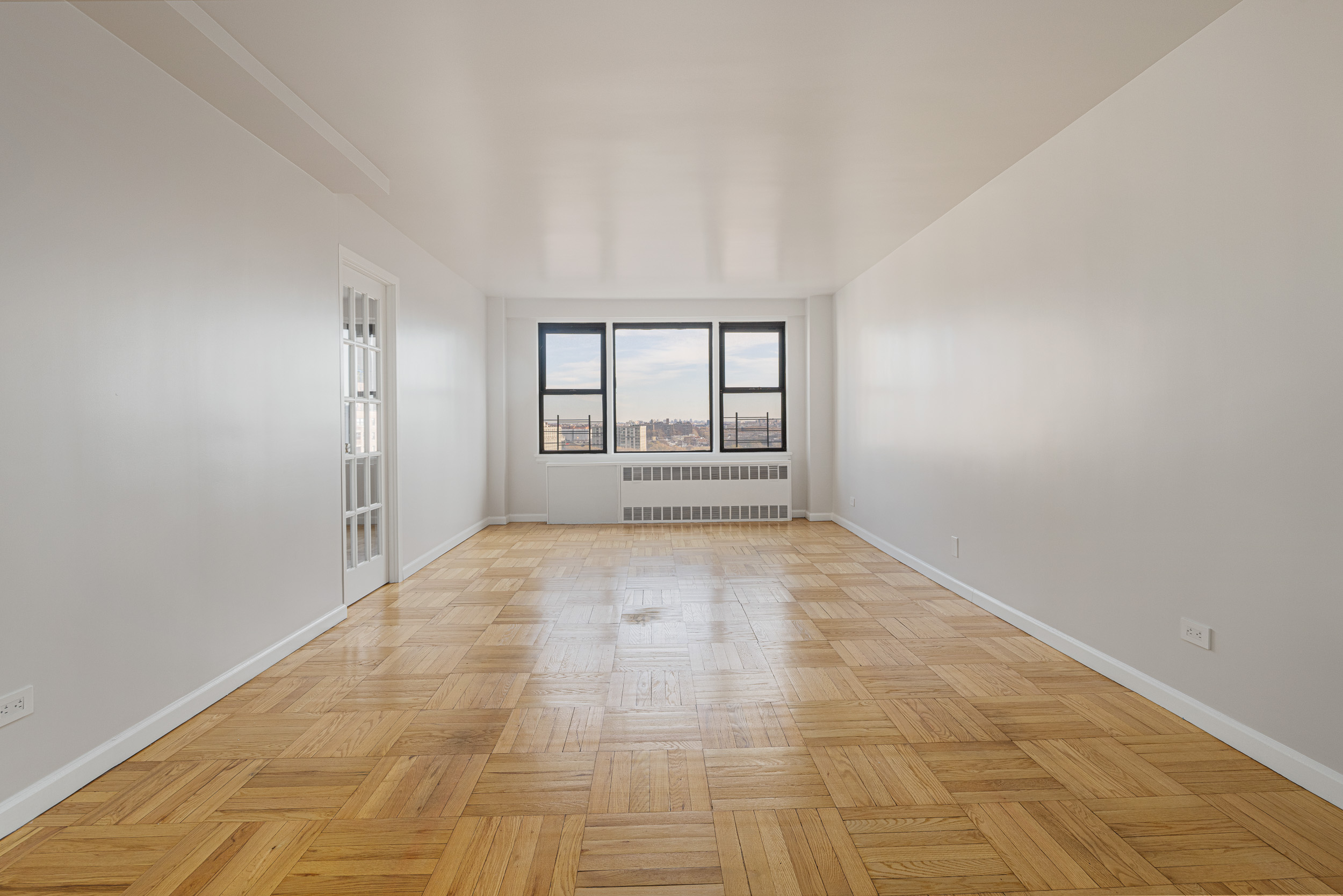 460 East 79th Street, Unit 15F Manhattan, NY 10075 - Photo 1 of 8 an empty room with large windows