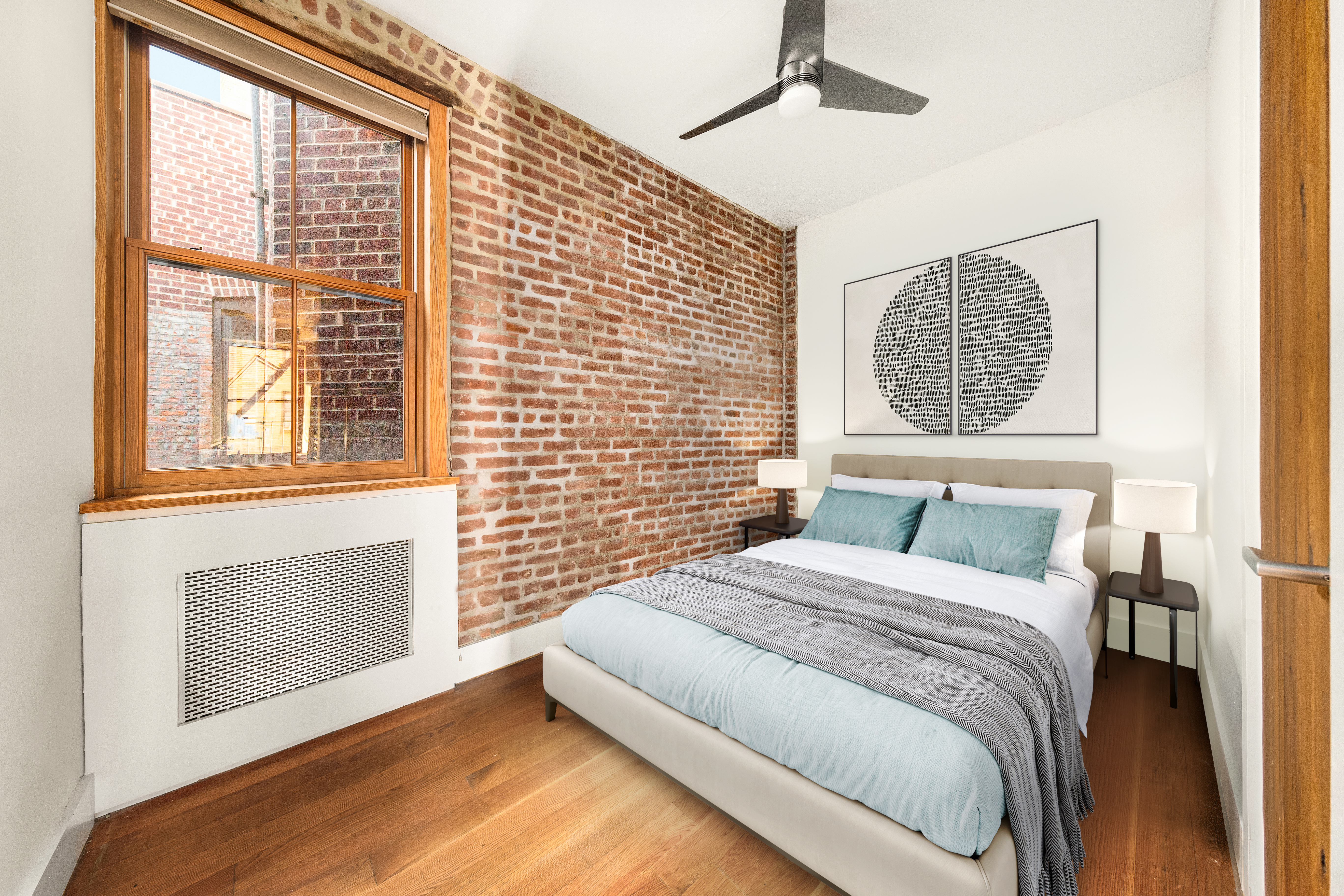 7 West 92nd Street, Unit 76 Manhattan, NY 10025 - Photo 5 of 11 a bedroom with a bed and a flat tv screen on dresser