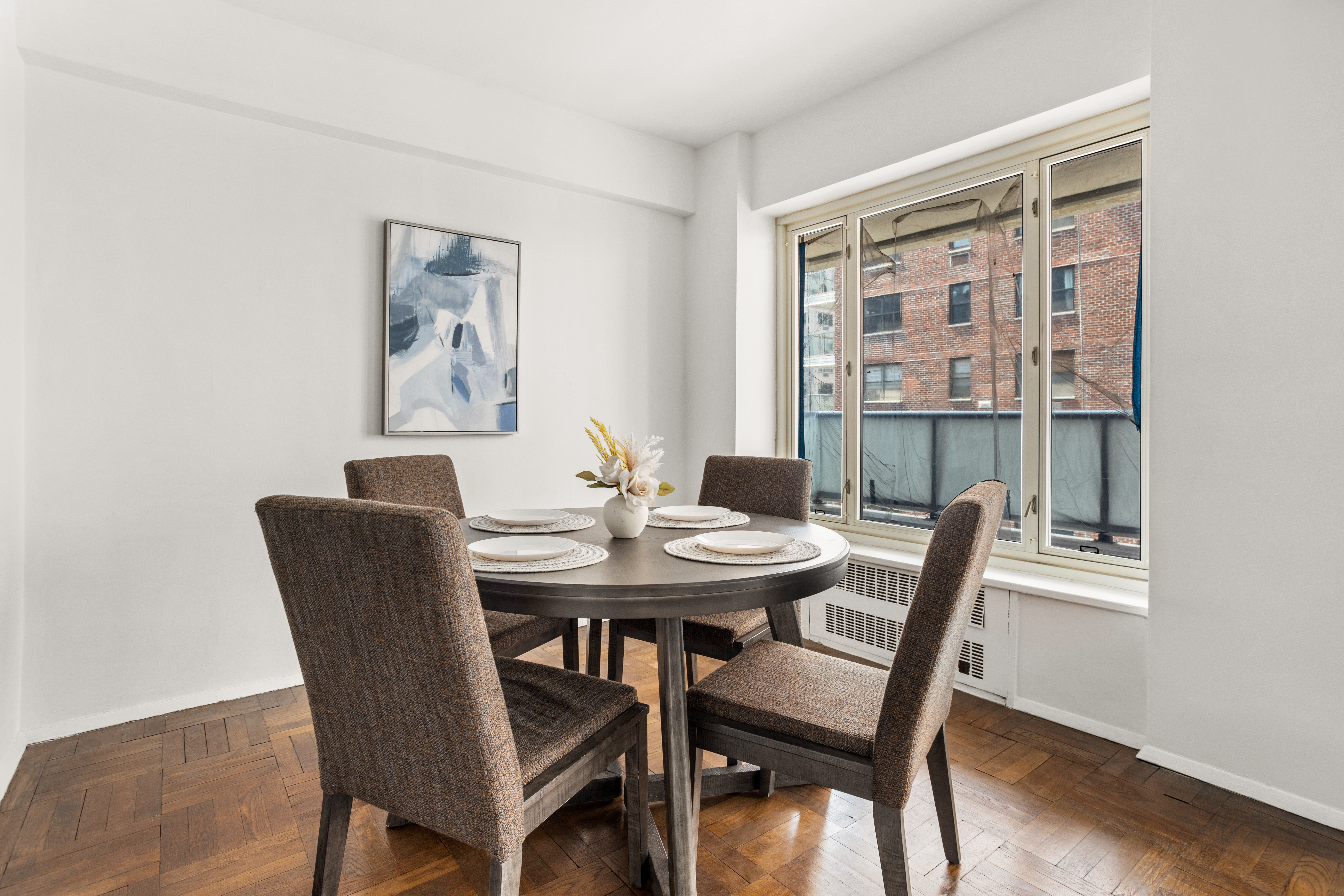 36 Sutton Place South, Unit 11D Manhattan, NY 10022 - Photo 3 of 11 a view of a dining room with furniture window and wooden floor