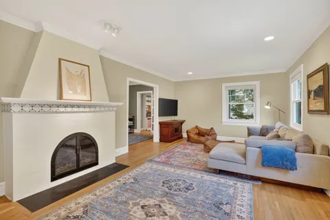 a living room with furniture two couches and a fireplace