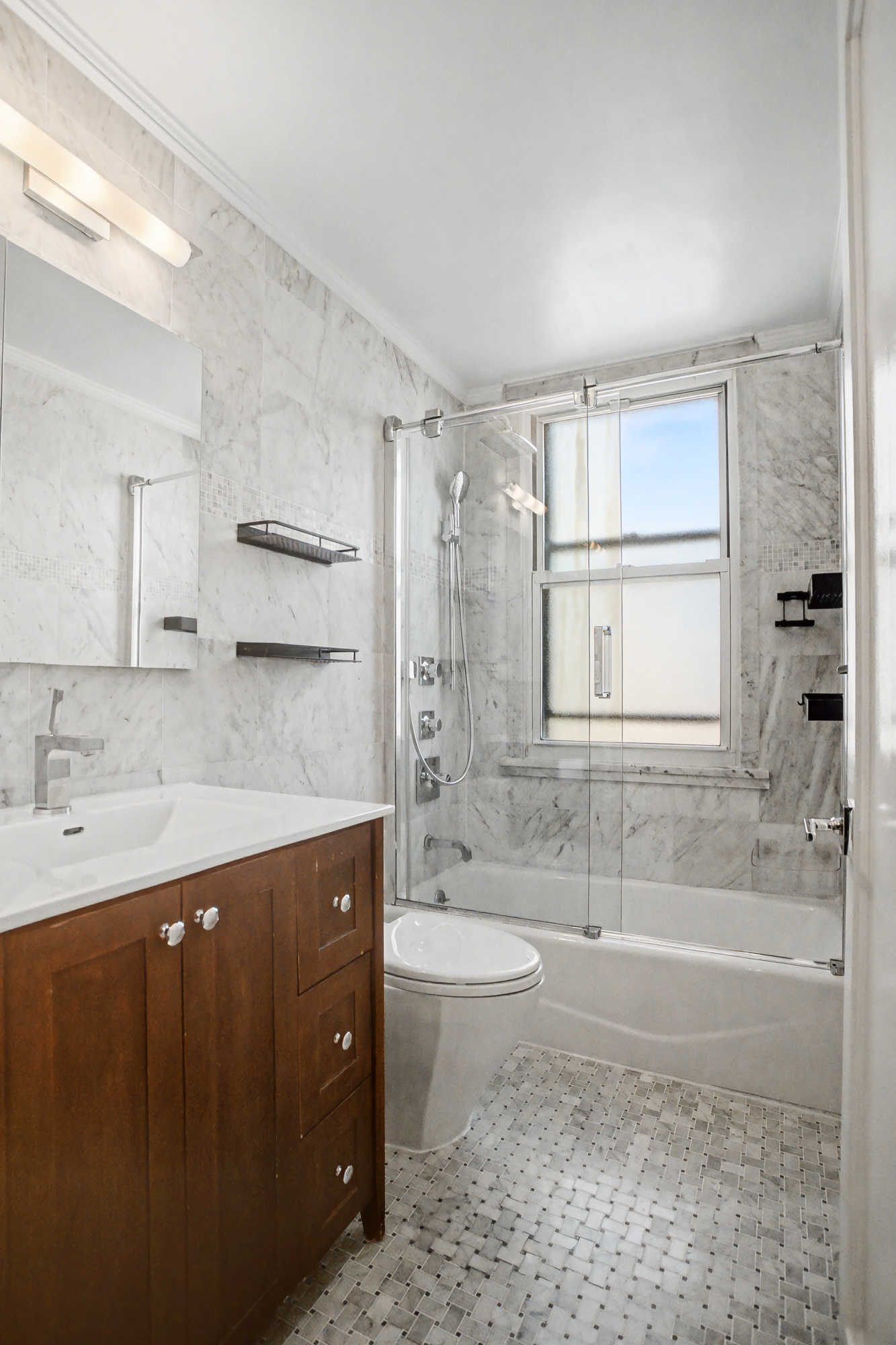 301 East 79th Street, Unit 17F Manhattan, NY 10075 - Photo 11 of 15 a spacious bathroom with a granite countertop sink a toilet a bathtub and shower