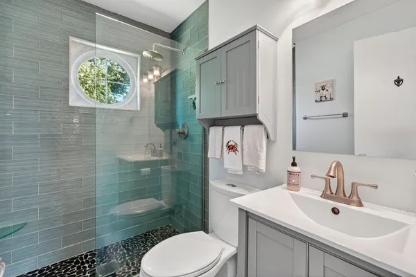 a bathroom with a sink toilet and shower