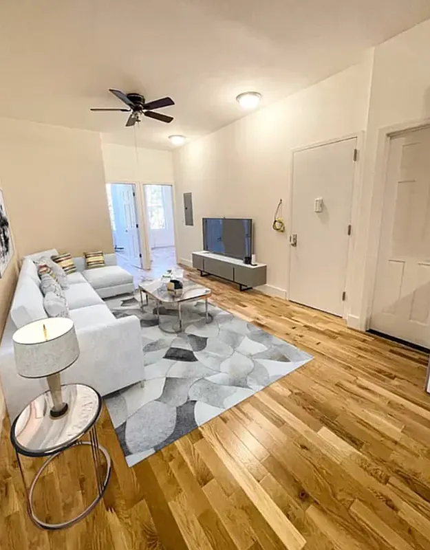 1128 Bushwick Avenue, Unit A Brooklyn, NY 11221 - Photo 6 of 14 a living room with furniture and a wooden floor
