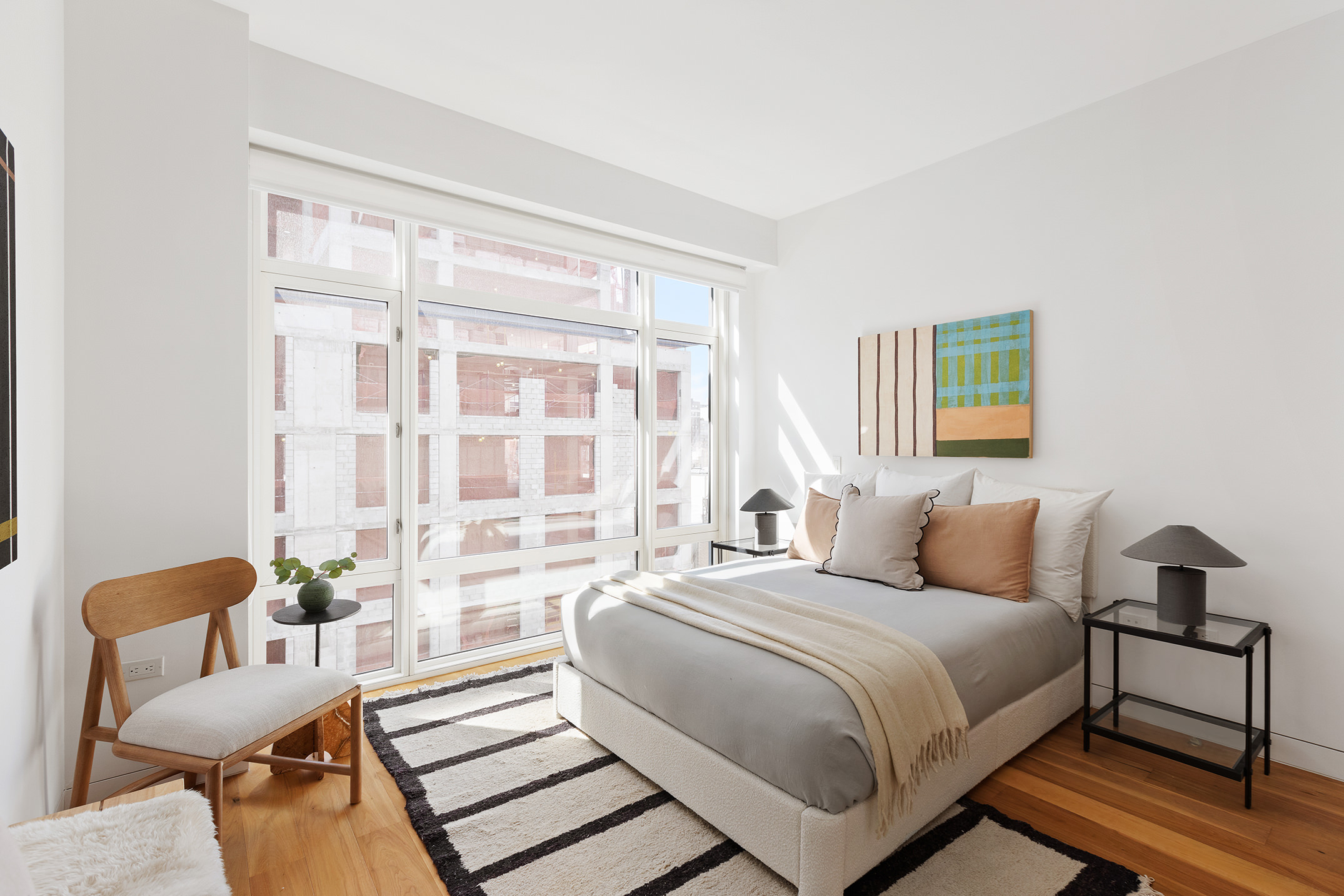 151 West 21st Street, Unit 9C Manhattan, NY 10011 - Photo 3 of 10 a bedroom with a bed and a couch