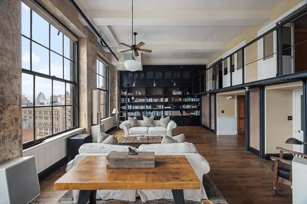 a living room with furniture fireplace and a large window
