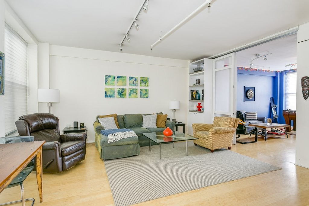 453 Washington Street, Unit 5D Boston, MA 02111 - Photo 5 of 17 a living room with furniture and a window