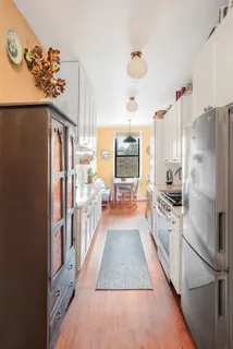 a kitchen with stainless steel appliances granite countertop a refrigerator and a stove