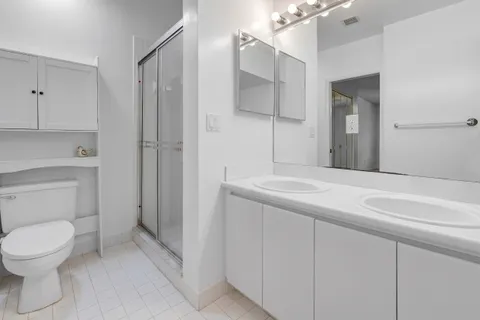 a bathroom with a toilet sink and shower