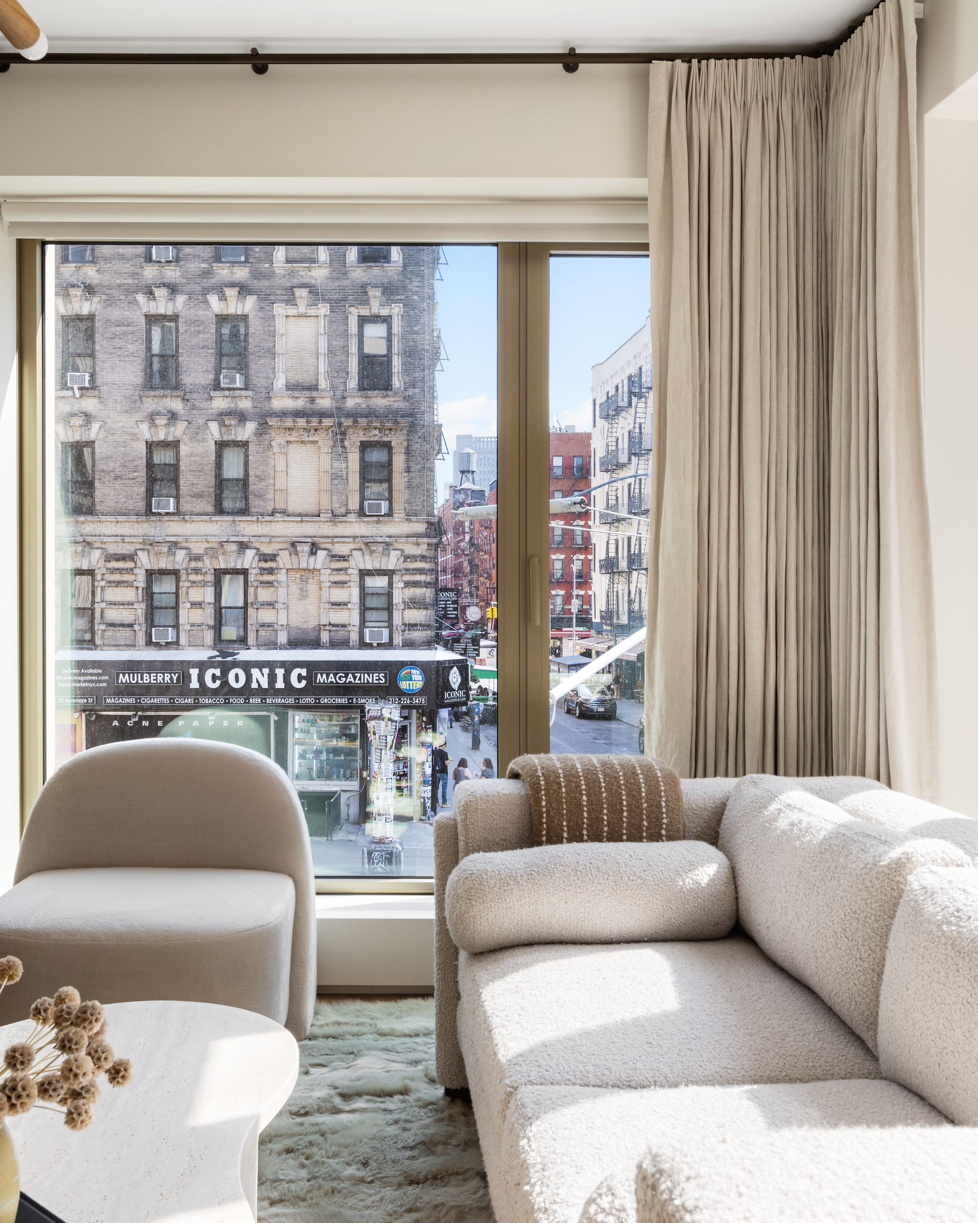 75 Kenmare Street, Unit 2D Manhattan, NY 10012 - Photo 9 of 15 a living room with furniture and a large window