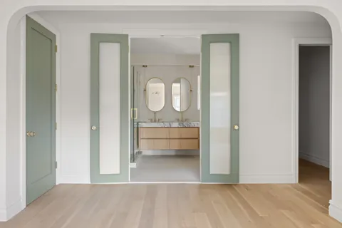 a bathroom with a tub a double vanity sink and mirror