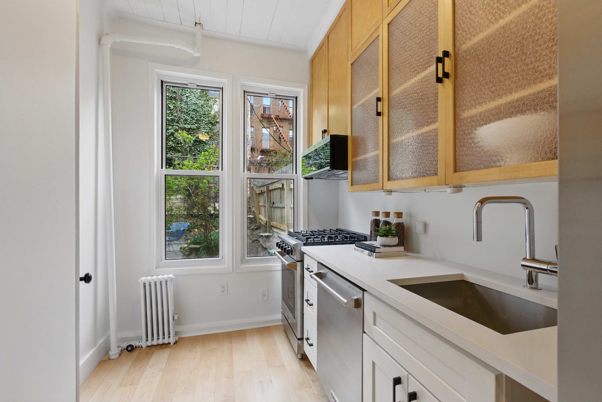 152 North 9th Street, Unit 1R Brooklyn, NY 11249 - Photo 5 of 13 a kitchen with a sink a stove and cabinets