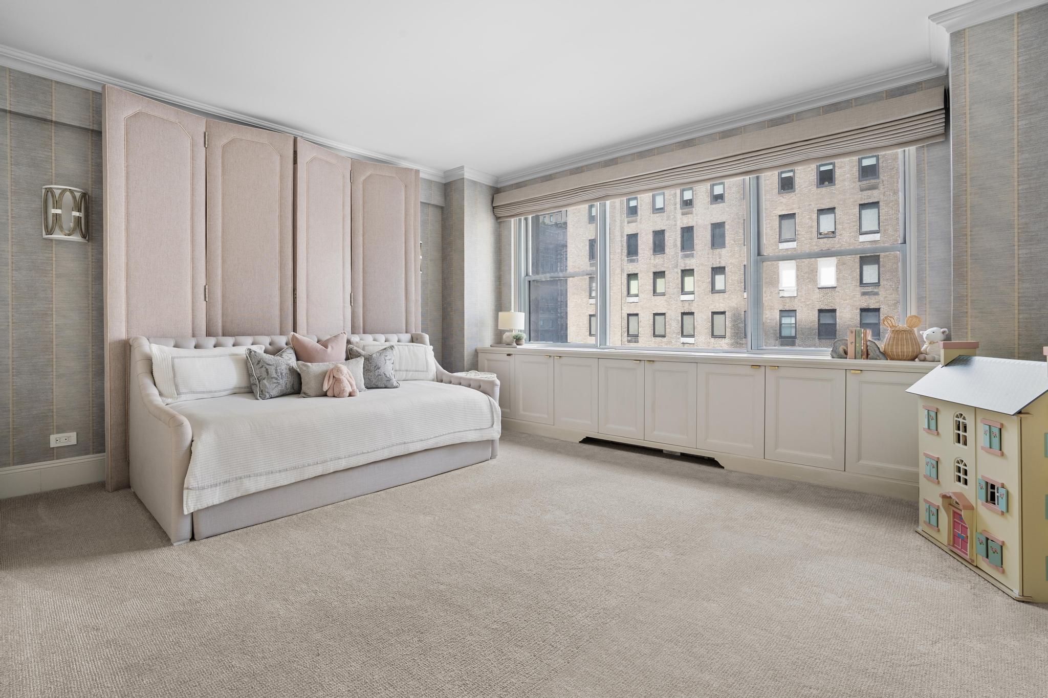 110 East 57th Street, Unit 10CD Manhattan, NY 10022 - Photo 12 of 16 a spacious bedroom with a bed and a window