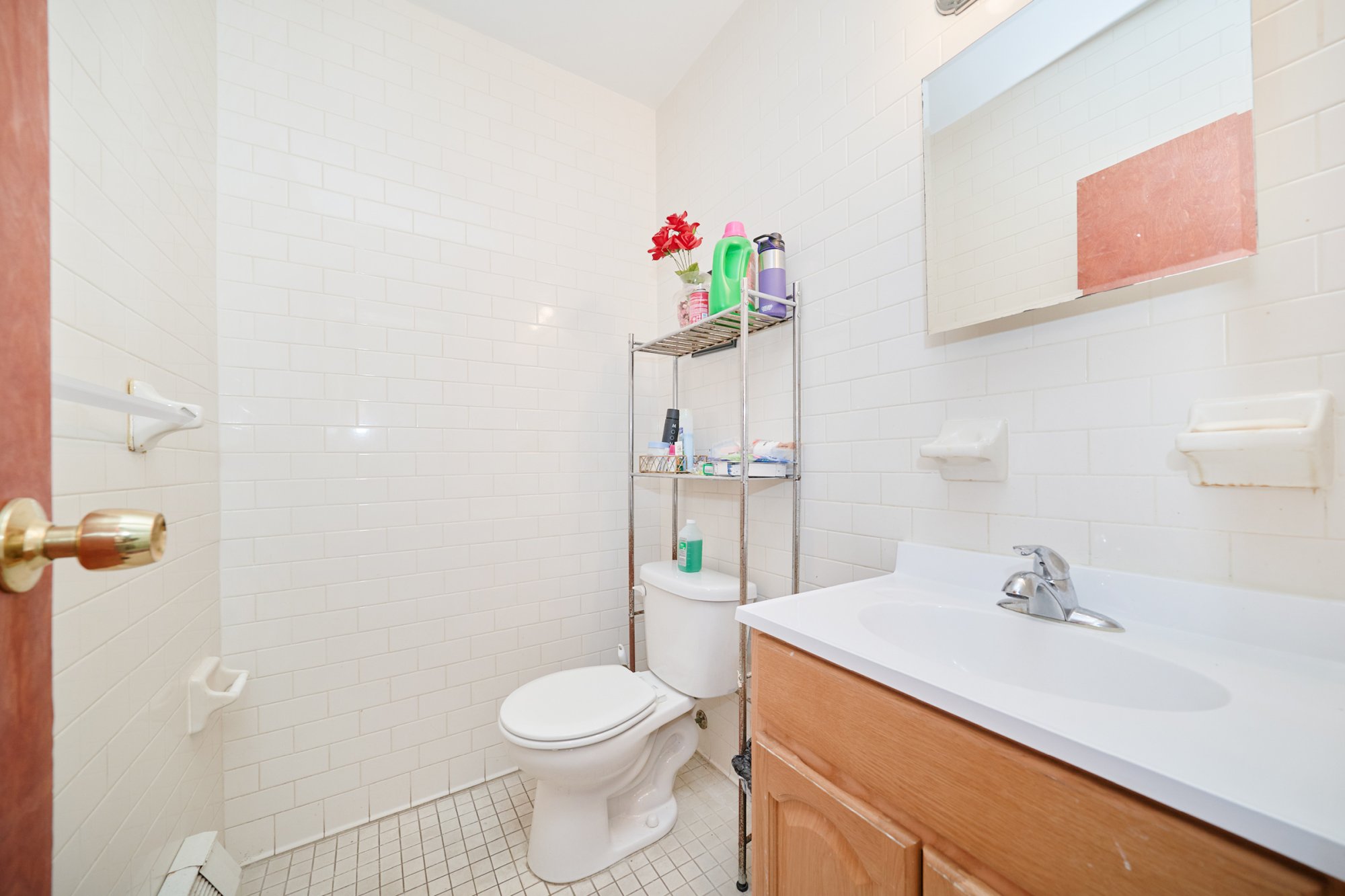 197 Edgecombe Avenue Manhattan, NY 10030 - Photo 4 of 12 a bathroom with a sink a toilet and a mirror