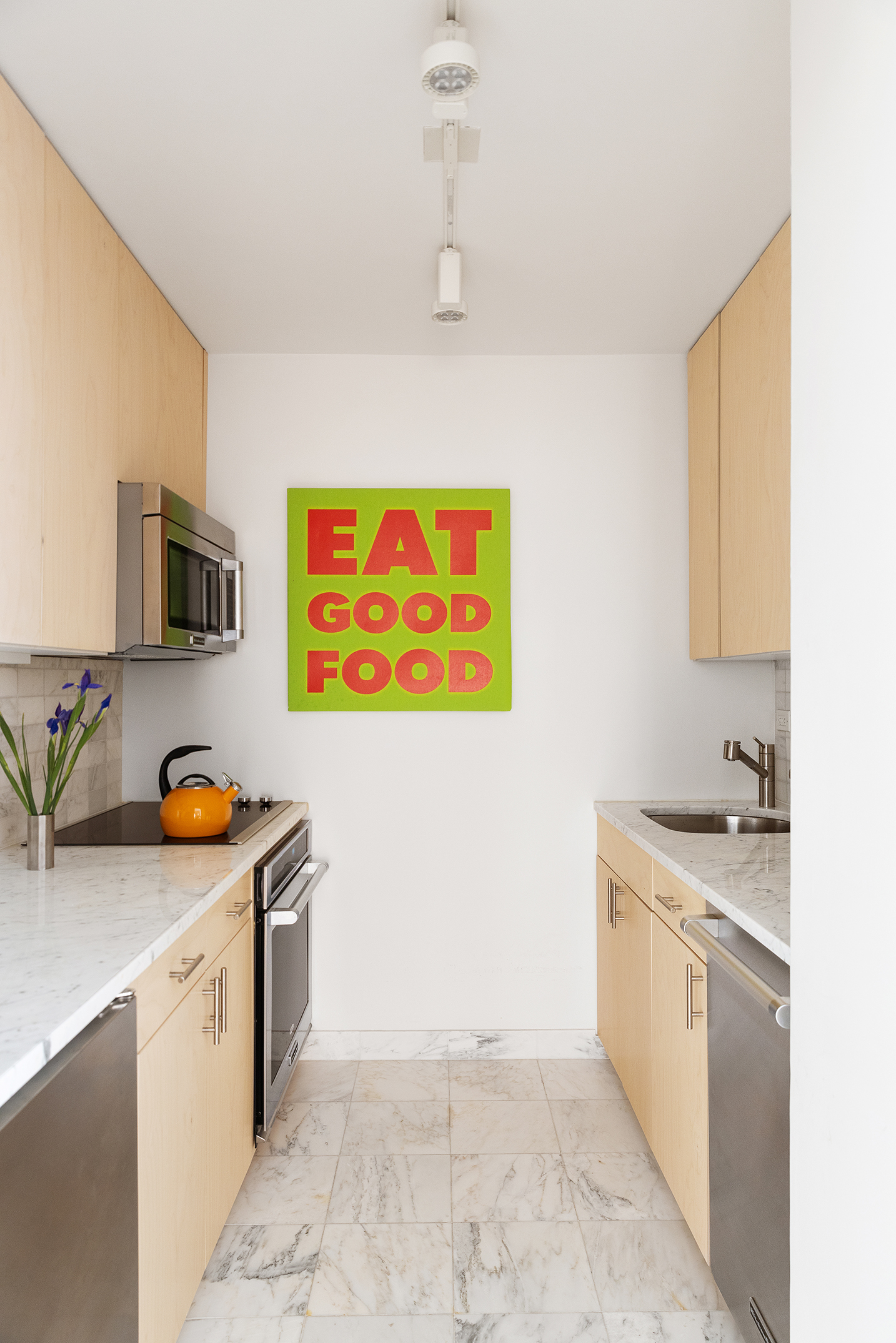 1065 Park Avenue, Unit 5BC Manhattan, NY 10128 - Photo 5 of 16 a view of a kitchen with stainless steel appliances granite countertop a stove a sink and a refrigerator