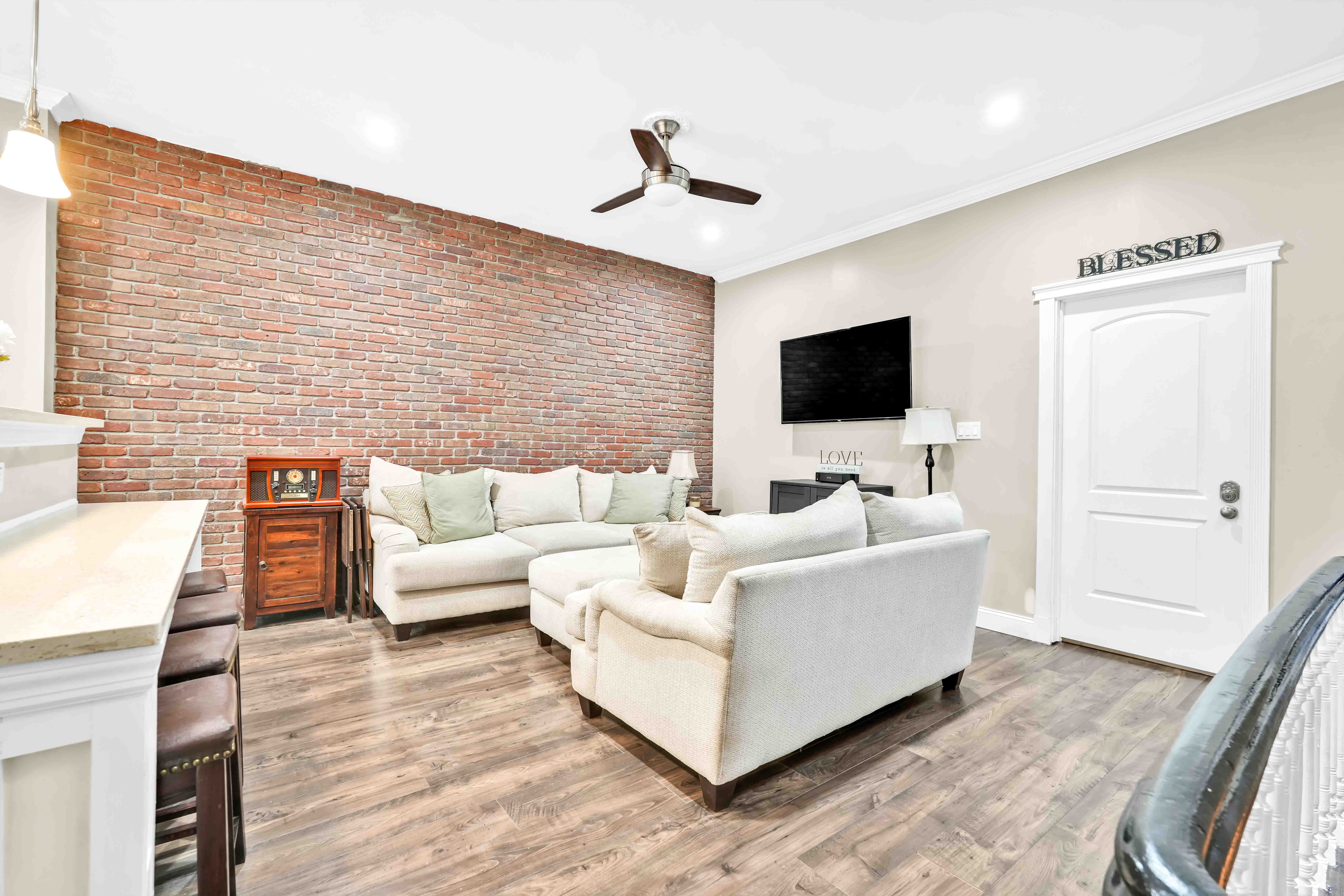 519 Monroe Street Brooklyn, NY 11221 - Photo 6 of 55 a living room with furniture and a flat screen tv