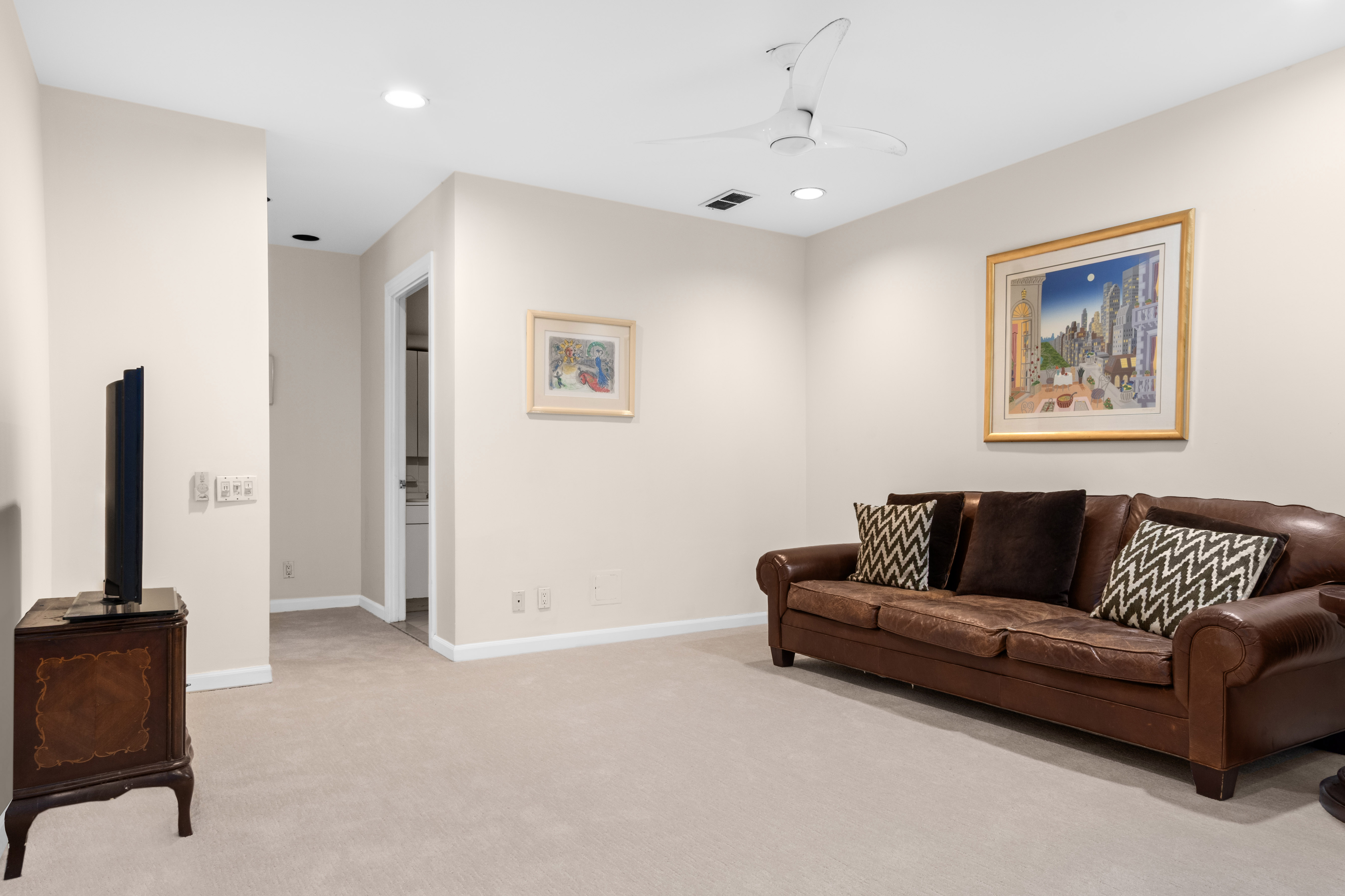 16 Sutton Place, Unit 1A/1B Manhattan, NY 10022 - Photo 13 of 25 a living room with furniture and a flat screen tv