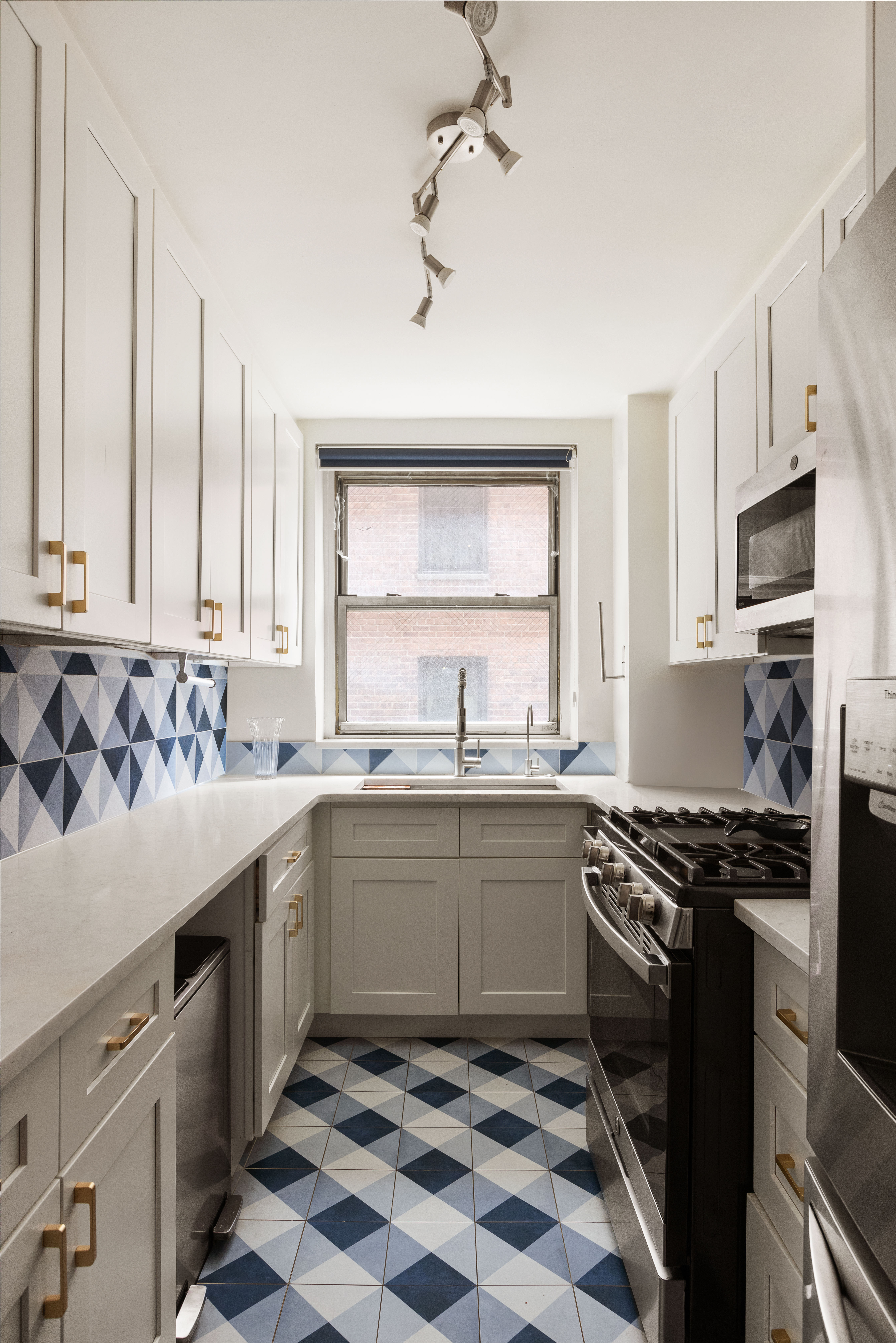 495 East 7th Street, Unit 2F Brooklyn, NY 11218 - Photo 2 of 10 a kitchen with stainless steel appliances granite countertop a sink stove top oven and cabinets