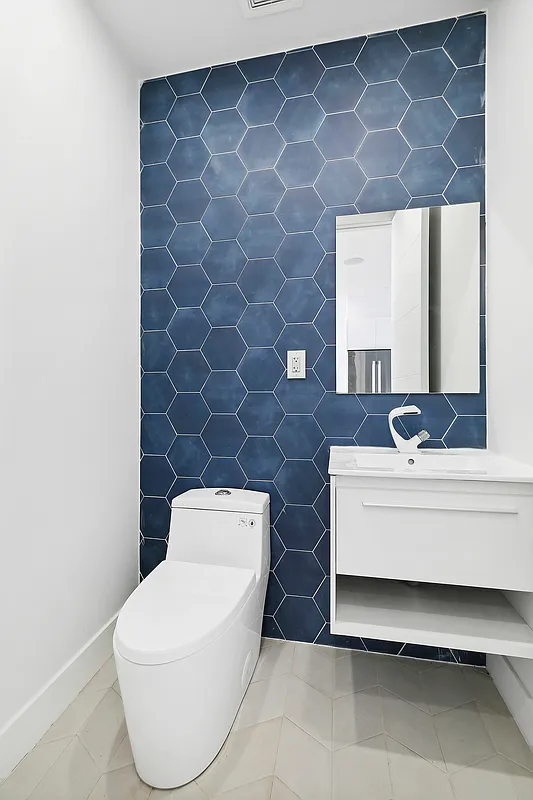 483 Hart Street, Unit PH Brooklyn, NY 11221 - Photo 11 of 17 a bathroom with a toilet a sink and mirror